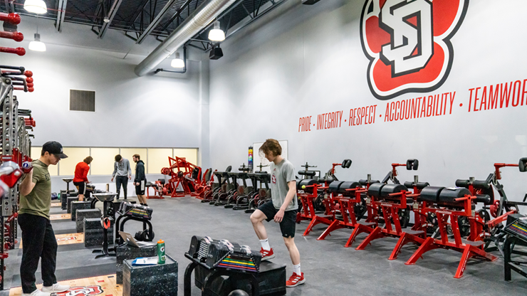 Students exercise in the strength and conditioning room.