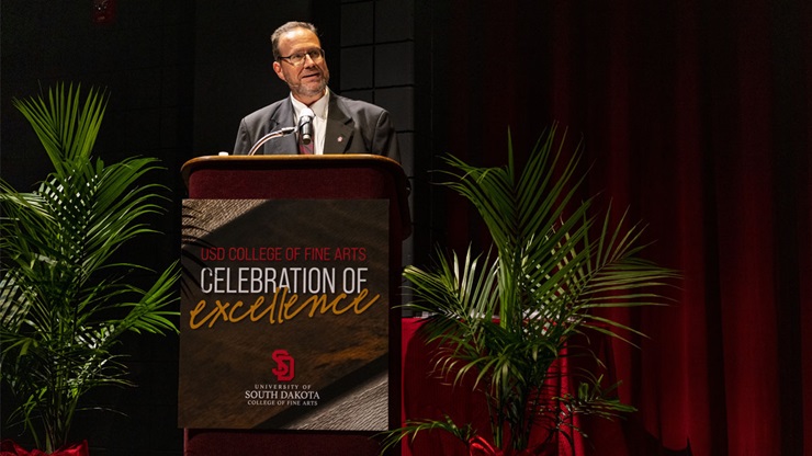 Bruce Kelley speaking behind the podium at the 2021 College of Fine Arts Celebration of Excellence