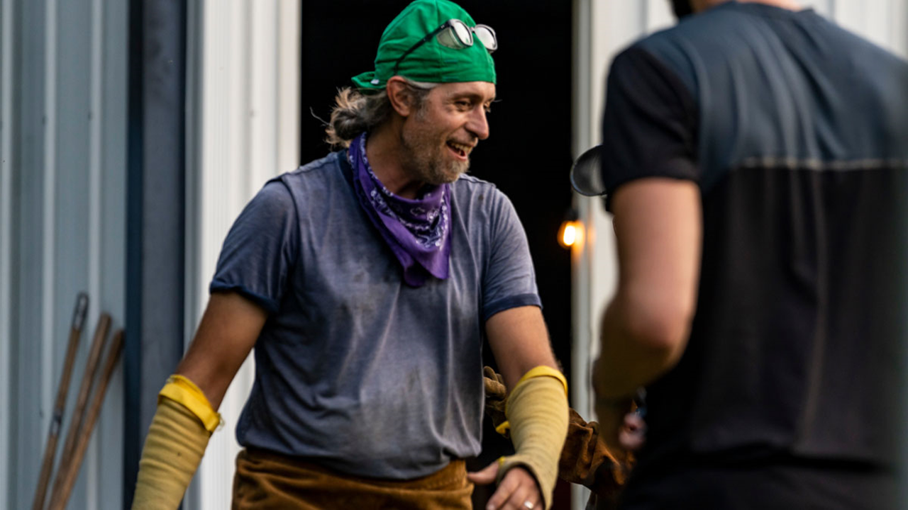 Chris Meyer smiles while working in an iron shop.