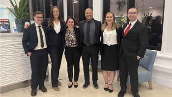 Six of USD's trial team members stand together in the photo