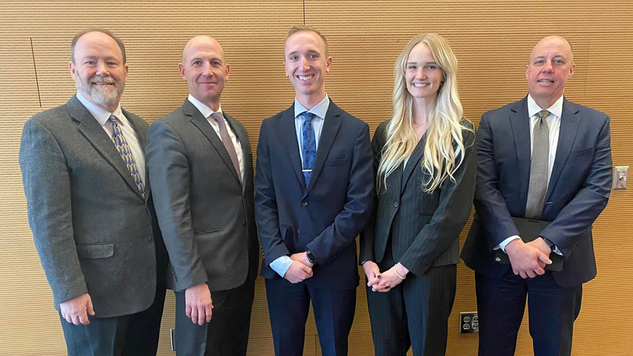 Five law students and professionals stand side by side for a photo.