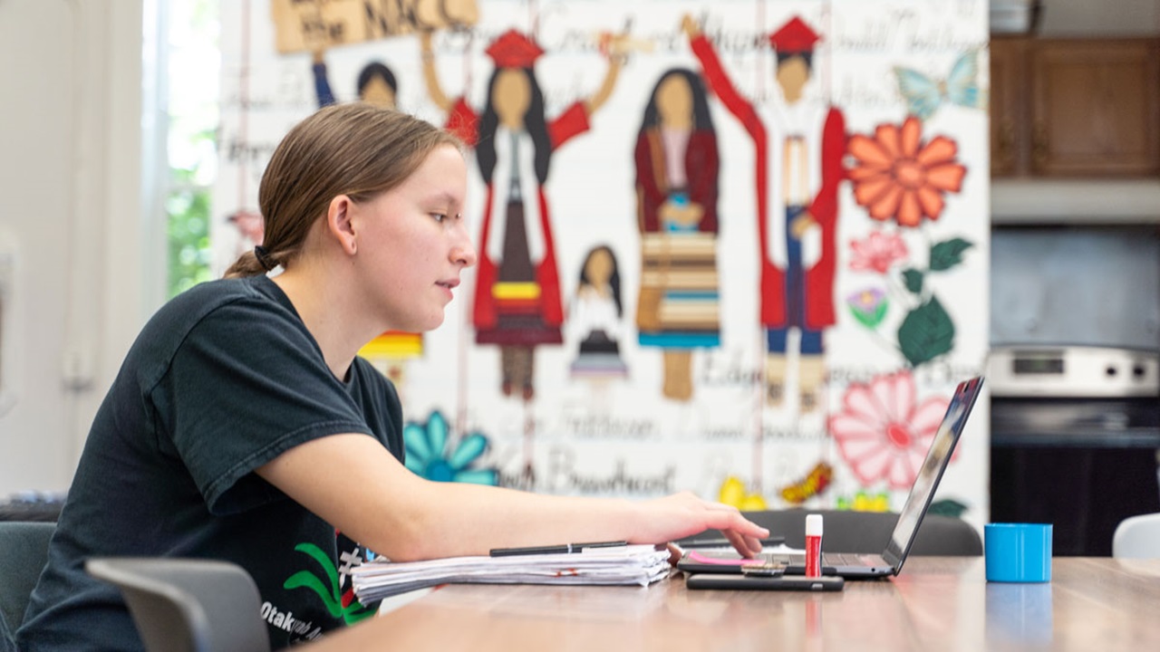 A student works on a computer in the Native American Cultural Center at USD A student works on a computer in the Native American Cultural Center at USD