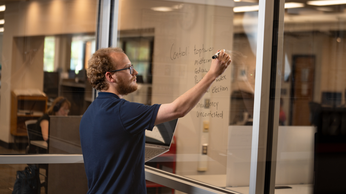 Evan Sippel works on his research project in the USD library 