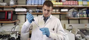 A medical biology student in a lab researching.