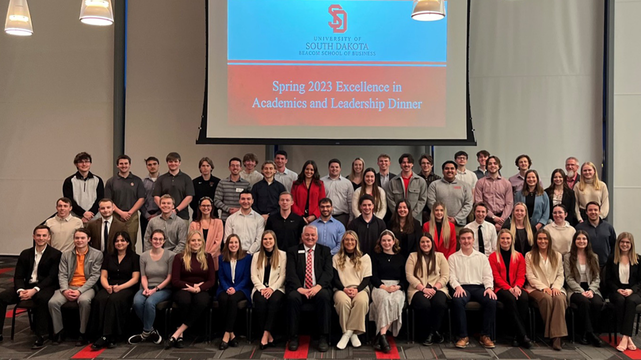 A large group of Beacom students pose together at the Beacom Excellence Dinner.