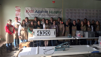 Kids Against hunger lined up in front of poster