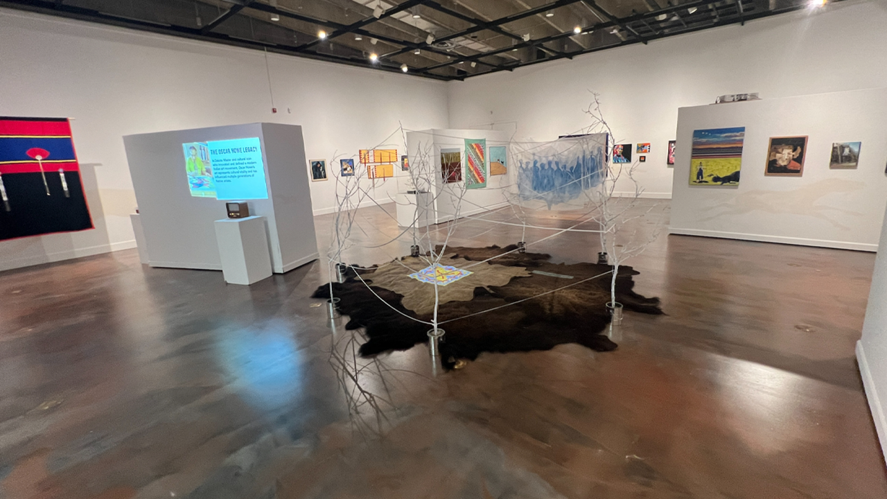 Varying mediums of art are spread out in an art gallery.