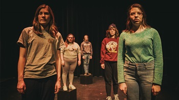 USD performers stand together in a line during a performance. USD performers stand together in a line during a performance.