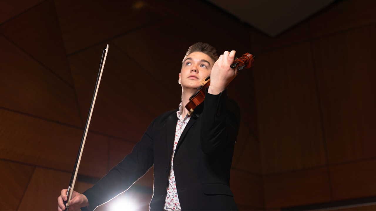 A photo of Wyatt Green playing the violin.