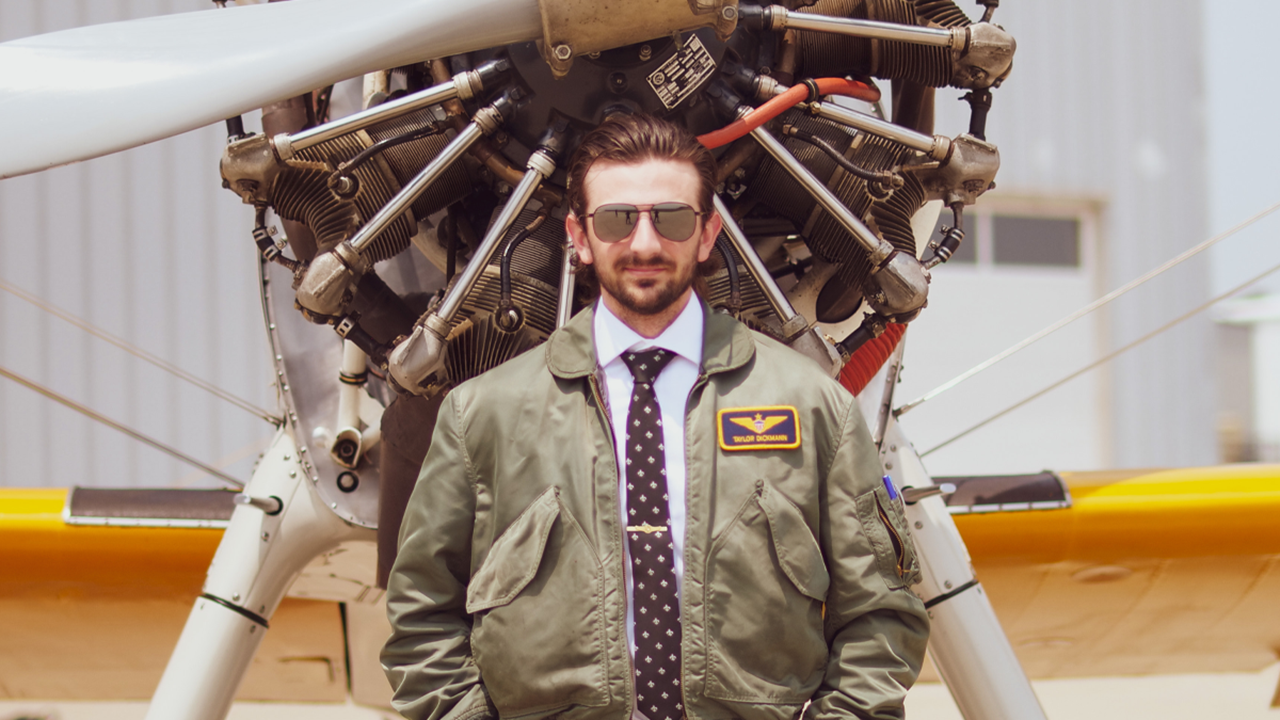 Taylor Dickmann stands in front of a plane.