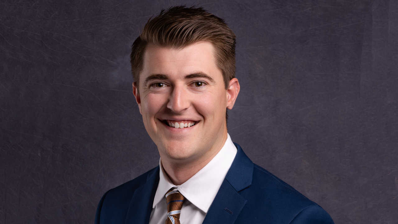 A headshot of Connor McCormick in front of a dark purple background.