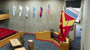 The nine tribal flags of South Dakota are seen hanging in the USD Knudson School of Law courtroom