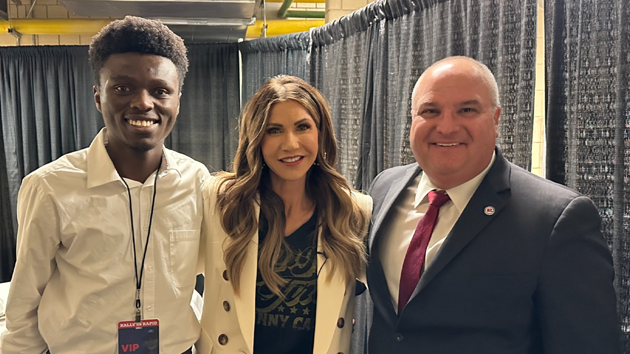 Finaisi Epapy stands with South Dakota Governor Kristi Noem and former chariman of the South Dakota Republican Party Dan Lederman.