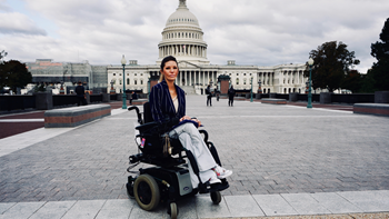 A person in a wheelchair in front of the U.S. Capitol.
