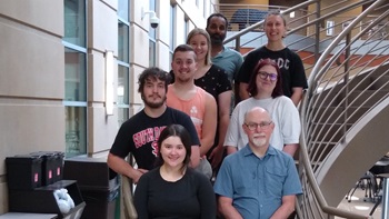 Maykala Mofle, Brian Burrell (SPURA Co-Director), Spencer Hurst, Tyson Junck, Sophia Van Bursick, Abigail Stelling,  Yohann Fernandes (mentor), Morgan Rothschadl (peer mentor) standing on a staircase.