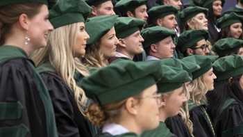 Sanford School of Medicine graduate stand together in their caps and gowns Sanford School of Medicine graduate stand together in their caps and gowns