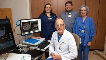 Dr. Daniel Petereit and his team posing for photo in medical room