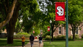 Students walking on campus in summer 