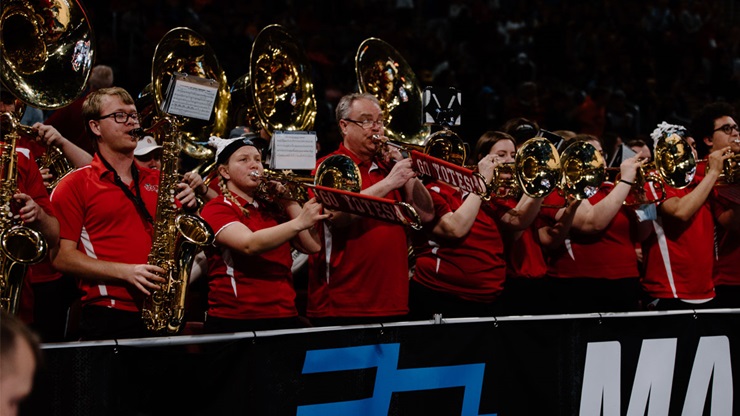Kurt Hackemer and The SOUND of USD play their instruments at a USD basketball game.