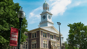 Old Main is featured in this photo on a bright blue summer day.