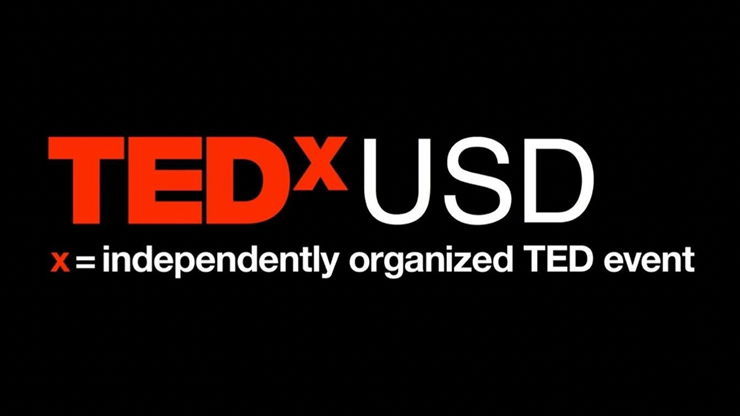 Red and white text that says TEDxUSD, x = independently organized TED event on a black background.