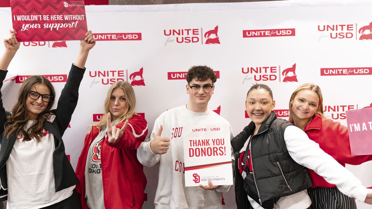 A group of students stand together in different fun poses to thank donors during Unite for USD A group of students stand together in different fun poses to thank donors during Unite for USD
