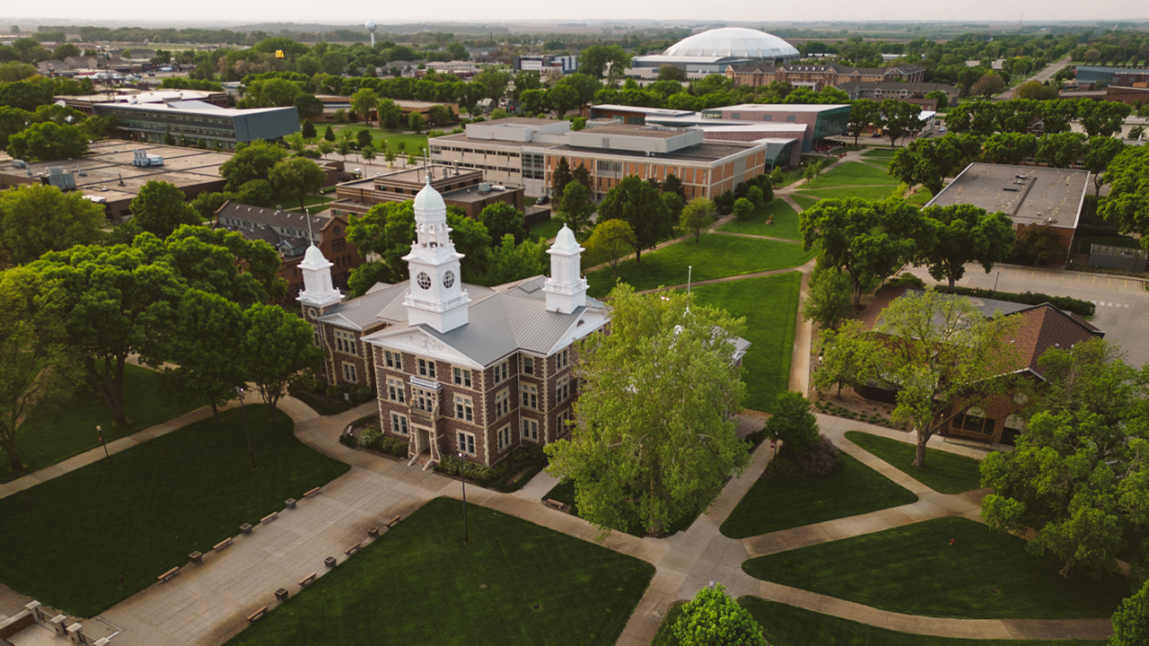 A drone shot of the University of South Dakota campus in Vermillion at dusk.