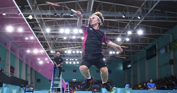 Miles Krajewski leaps in the air to volley a birdie over the net. Miles Krajewski leaps in the air to volley a birdie over the net.