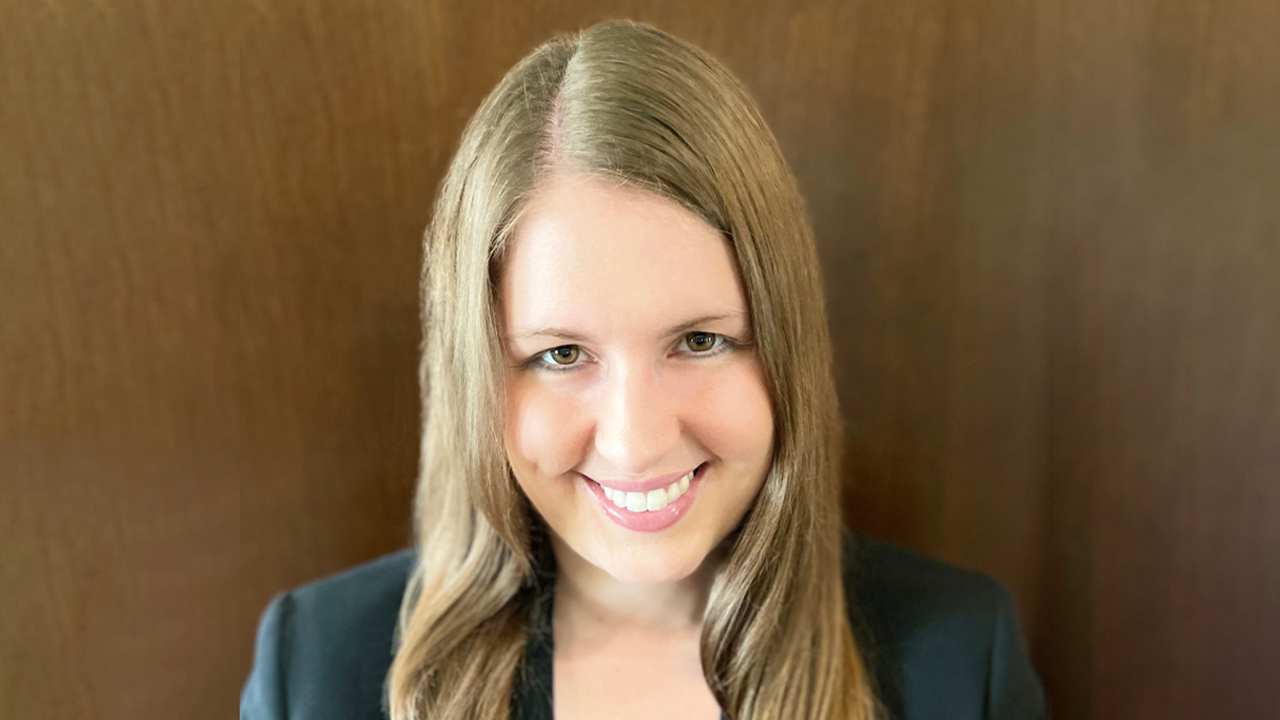 A headshot of BreAnne Danzi against a wood background.