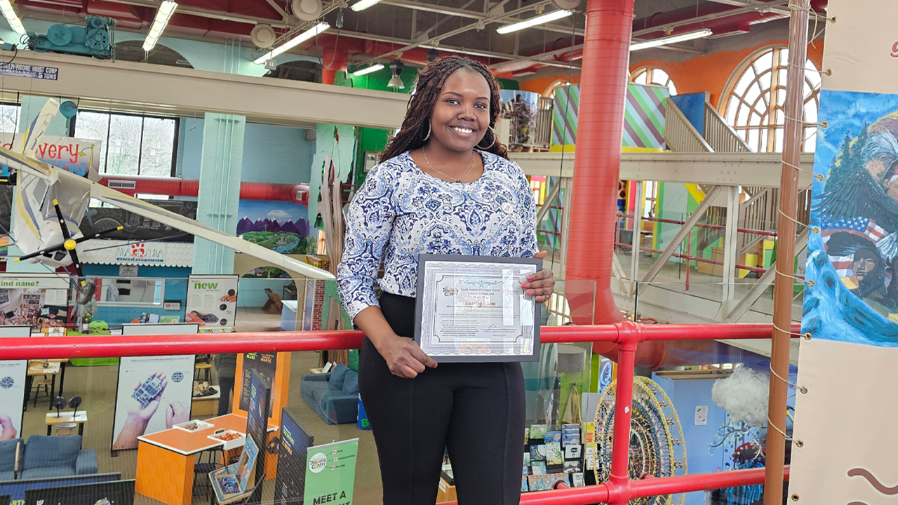 Blessing Ishola holds her fellowship certificate.