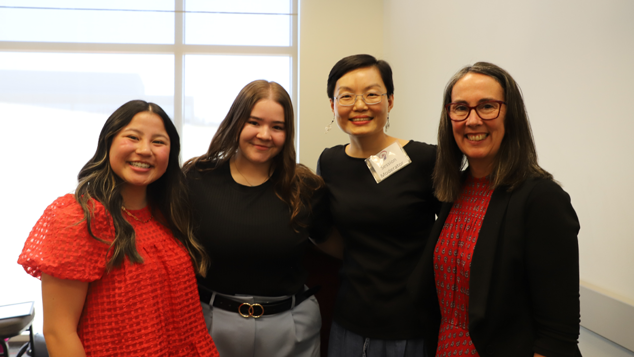 Lily Hilt, Brooke Creviston, Jing Williams and Sam Goldsmith stand together for a photo.