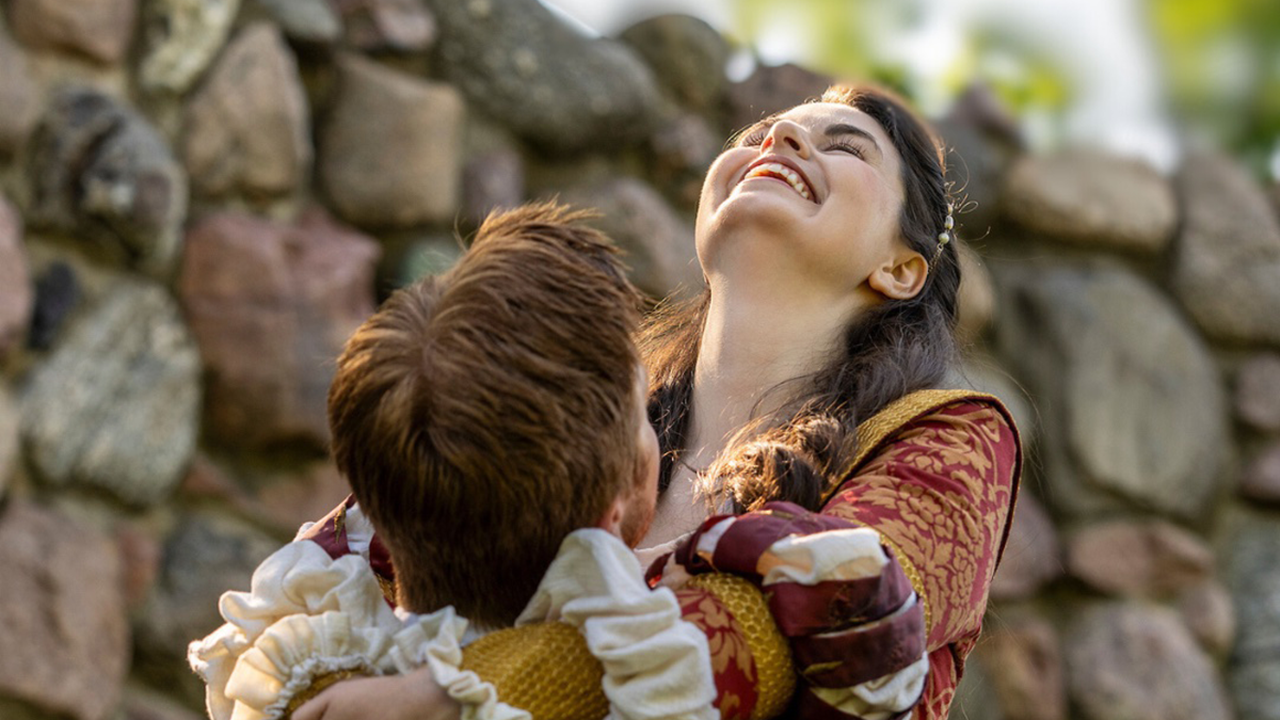 Actors embrace each other while wearing Shakespeare-era outfits.