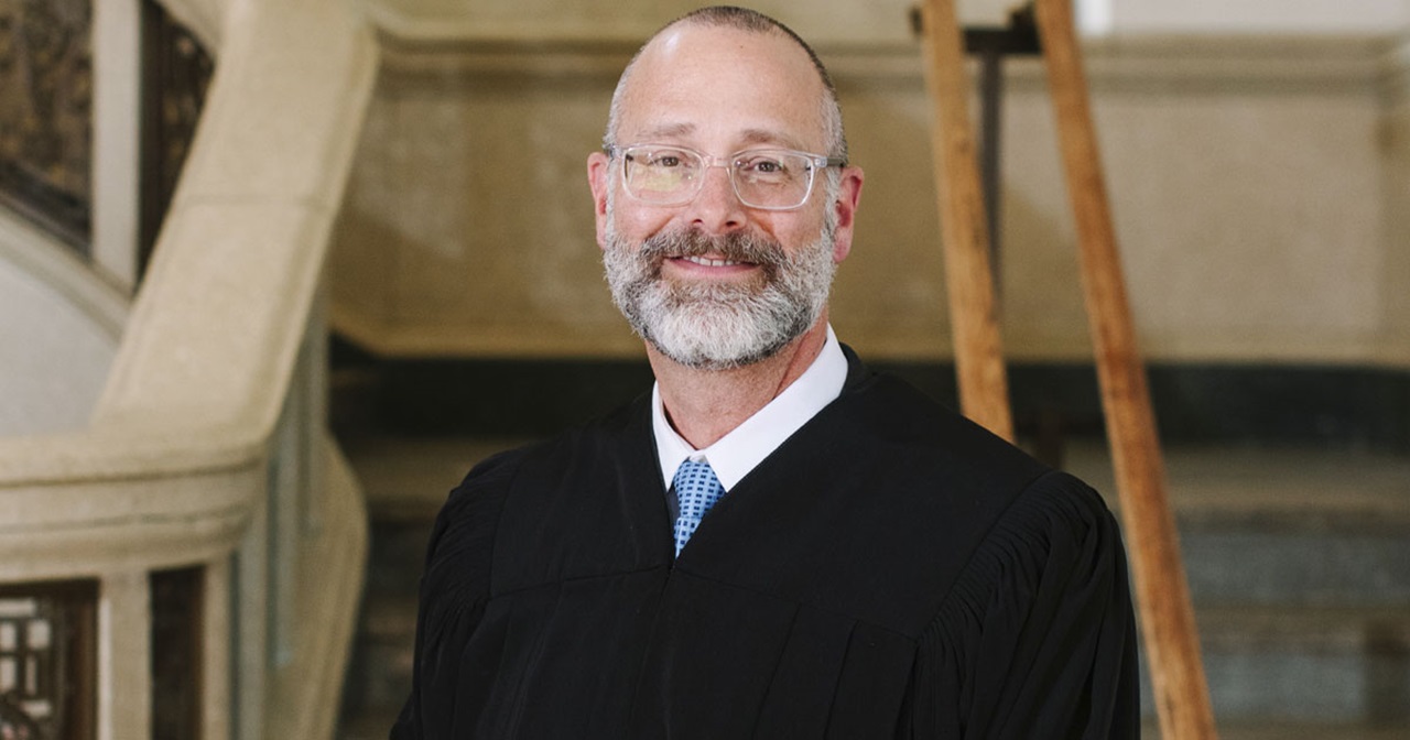 South Dakota Circuit Court Judge Scott Roetzel in his robes, smiling. South Dakota Circuit Court Judge Scott Roetzel in his robes, smiling.