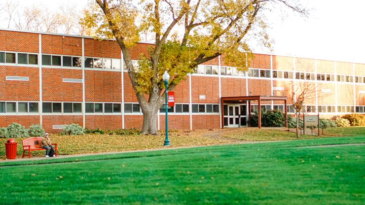 The Delzell Education Center, home of USD's School of Education, sits on a sunny campus surrounded by fall leaves and students.