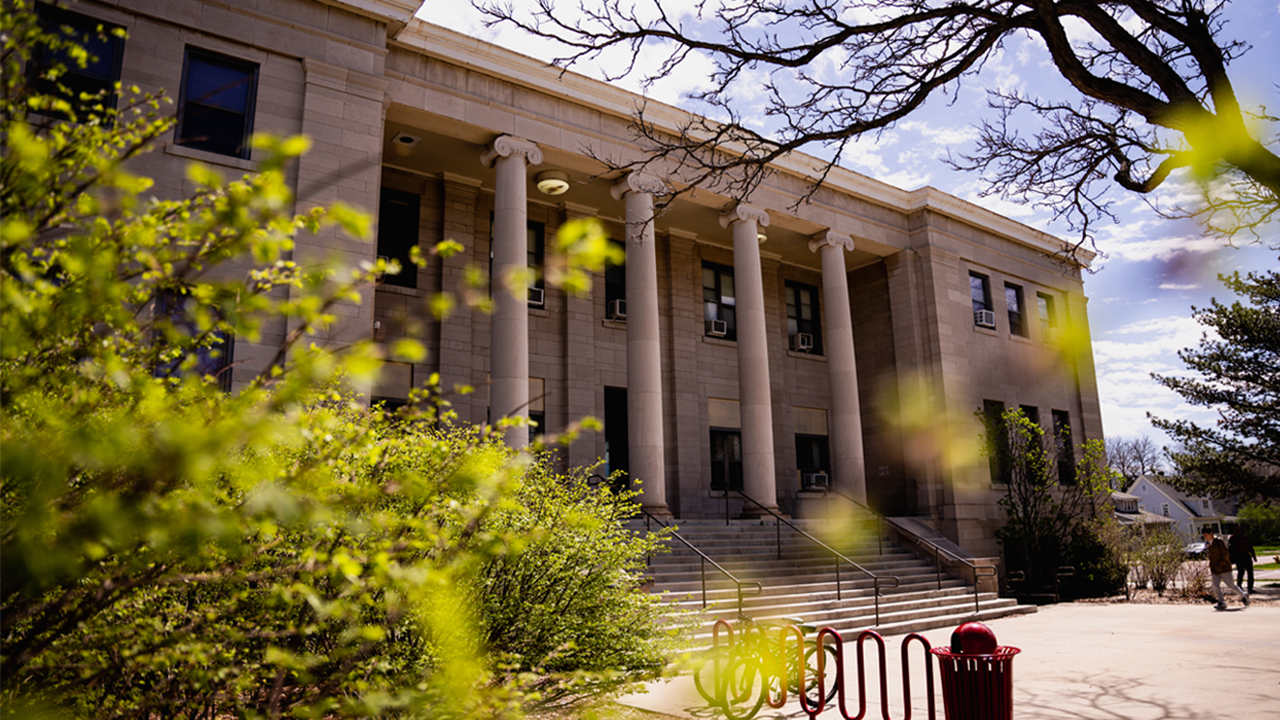 The College of Arts & Sciences building sits on campus on a beautiful sunny day.