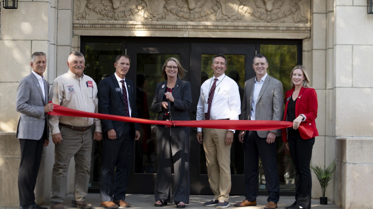 President Gestring along with South Dakota legislators and Board of Regents members cut a red ribbon in front of the doors of the South Dakota Union building. President Gestring along with South Dakota legislators and Board of Regents members cut a red ribbon in front of the doors of the South Dakota Union building.