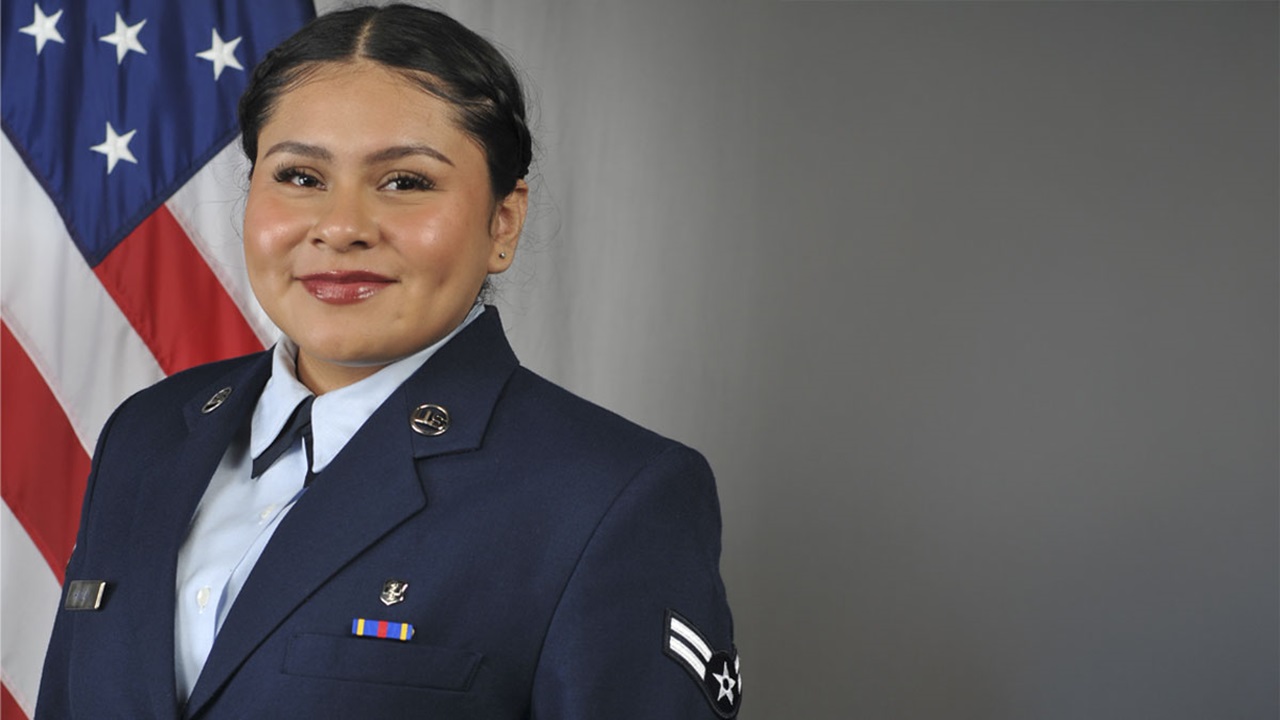 Anna Harlan in her uniform, standing in front of an American flag.  Anna Harlan in her uniform, standing in front of an American flag.