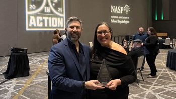 Kari Oyen poses with her award from the NASP.