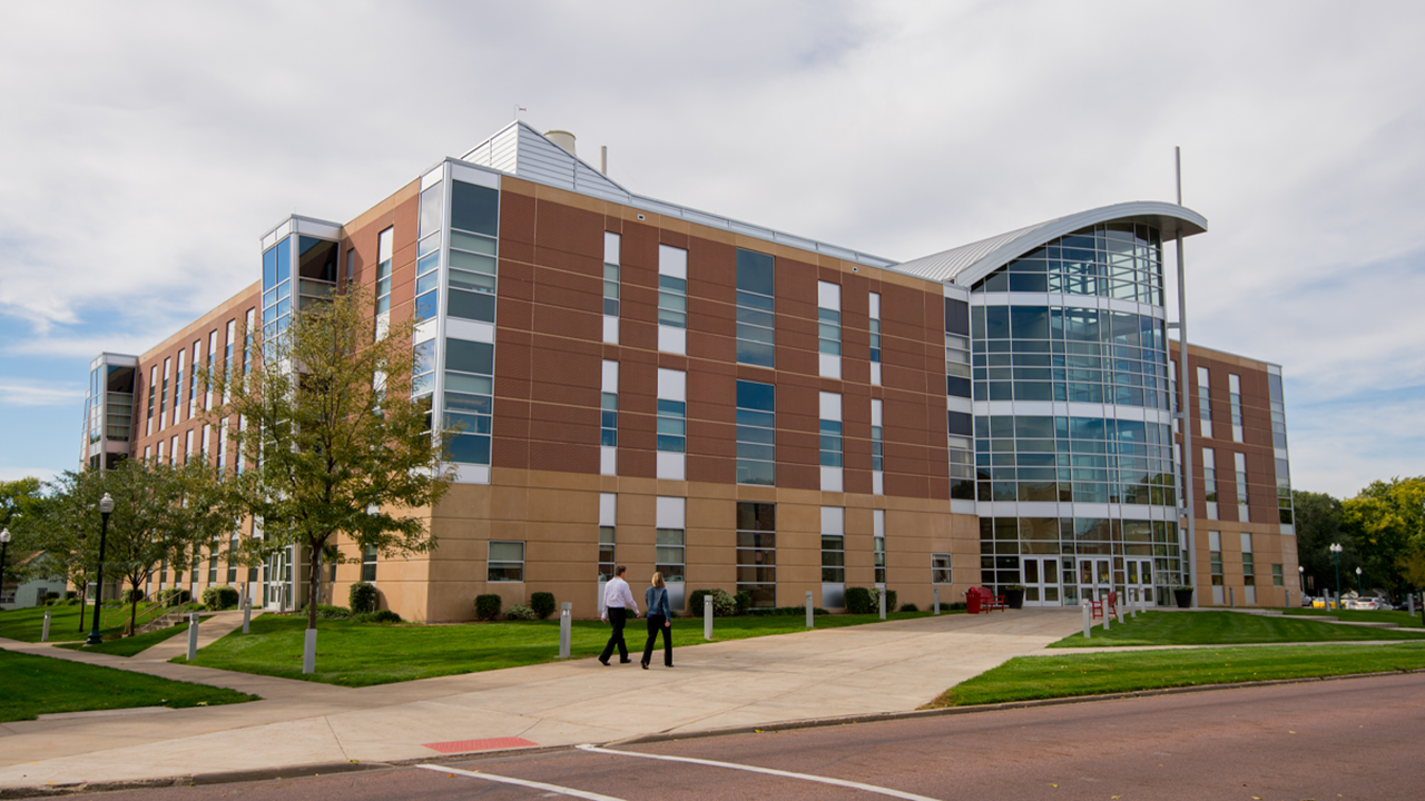 Students walk in front of the Lee Medical Building on the USD campus.