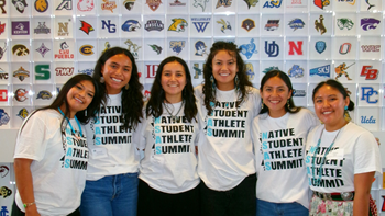 Matayah Yellow Mule (second from the left) stands with other Native Student Athlete Summit attendees for a photo. They are wearing Native Student Athlete Summit shirts.