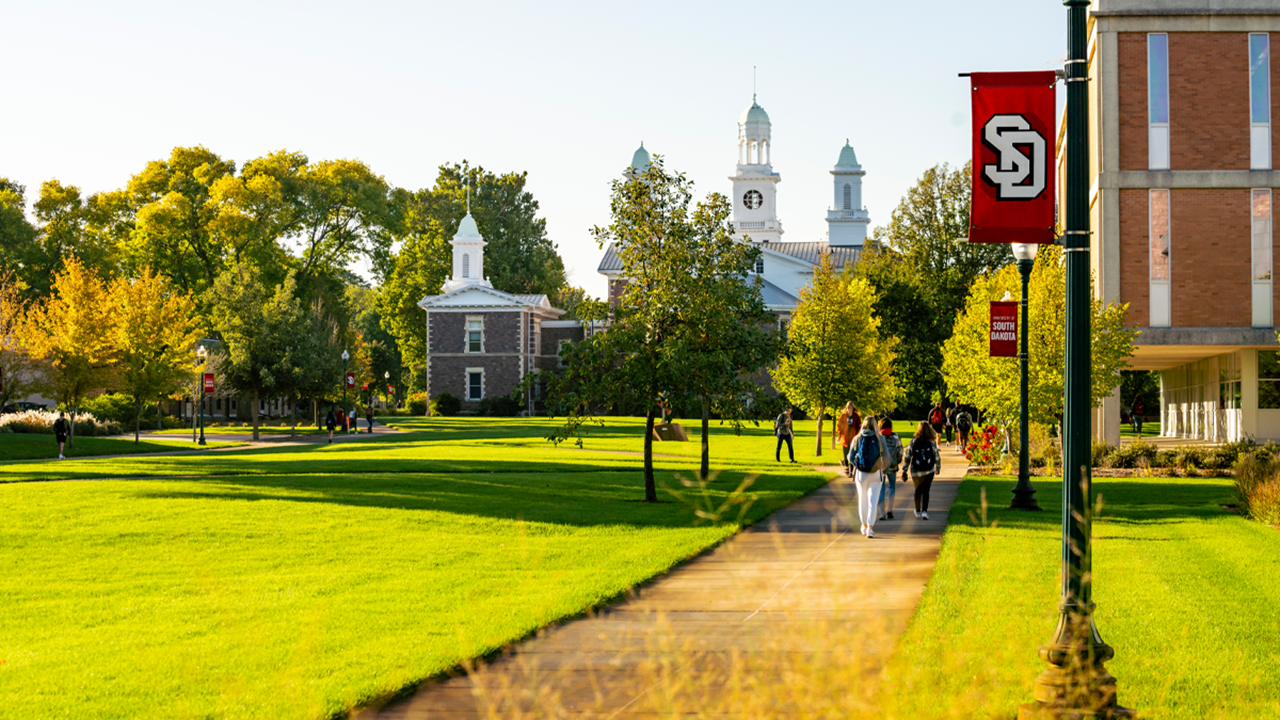 Students walk the USD campus on a spring morning.