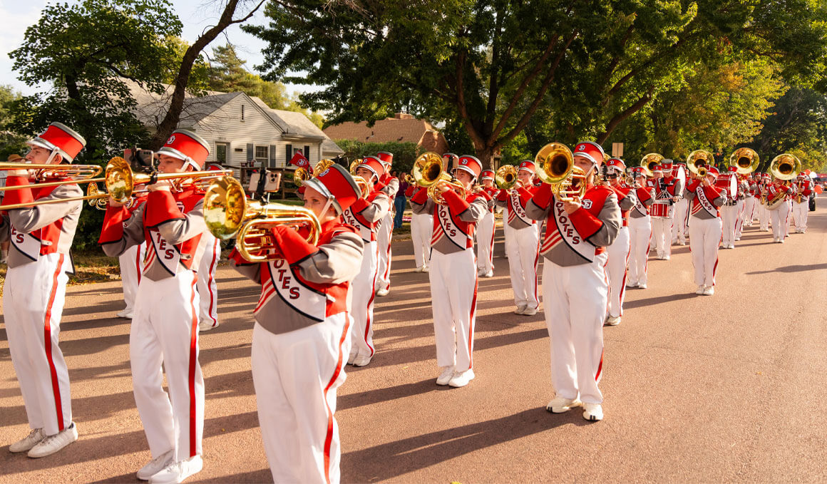 The SOUND of USD marches through a street in their uniforms during a Dakota Days Parade.