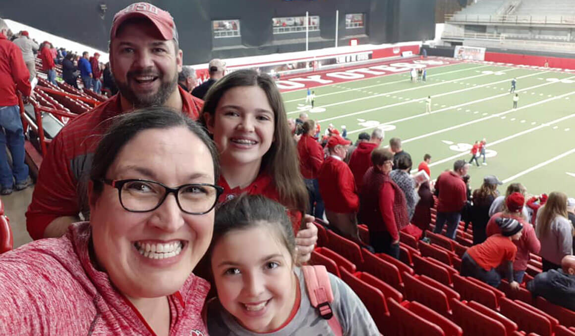 Kari Oyen poses for a photo with her family inside the DakotaDome during a football game.