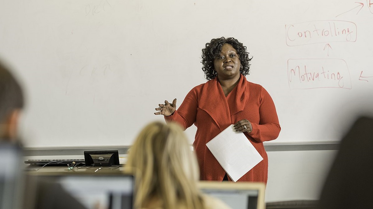 A USD professor lectures in front of her students.