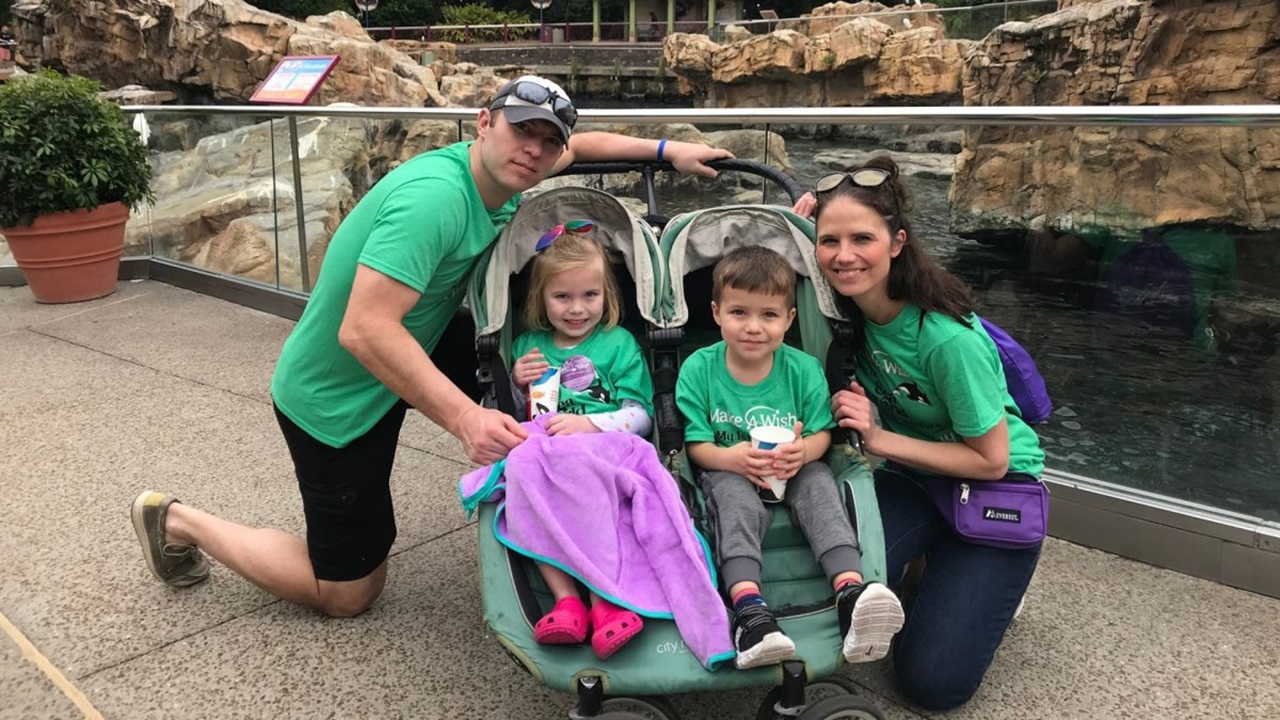 A family of four poses for a picture.