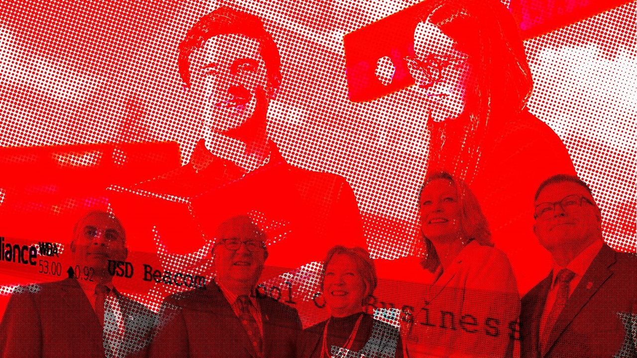 USD academic and business leaders stand in front of red screen.