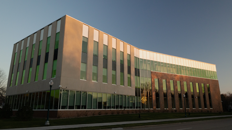 The outside of USD's School of Health Sciences building at sunset.