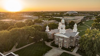 A drone shot of Old Main in the sunset