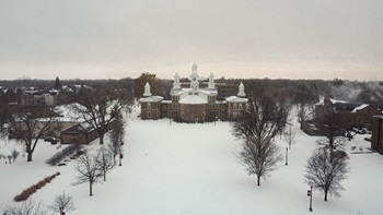 Old Main is centered on USD's campus. It's a snowy, gray day.