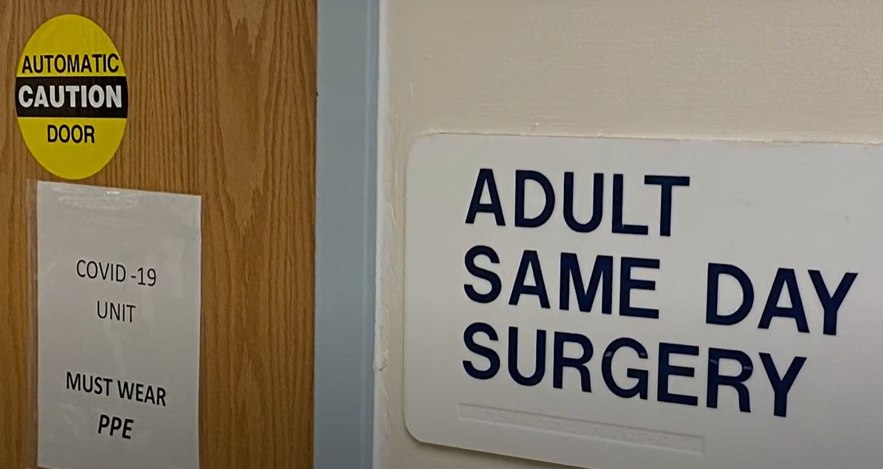 A hospital door with signs on it.